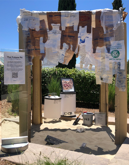 Sand pit transformed into a futuristic archaeological dig with plastic bags and other plastic items in it