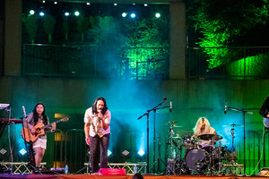 Photo of the band Run River North performing on an outdoor stage at the Skirball