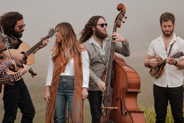 Photo of the band Nefesh standing outside on a hilltop playing their instruments