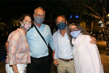 A group of four masked people posing outdoors at the Skirball