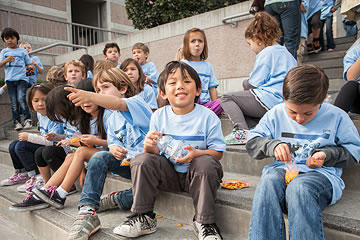 Students eating snacks on the front steps