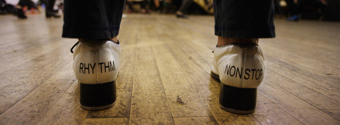 Tap shoes with the words "rhythm" and "nonstop" printed on them
