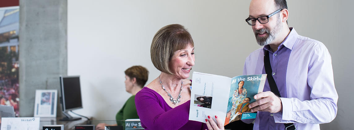 Man and woman looking at Skirball brochure