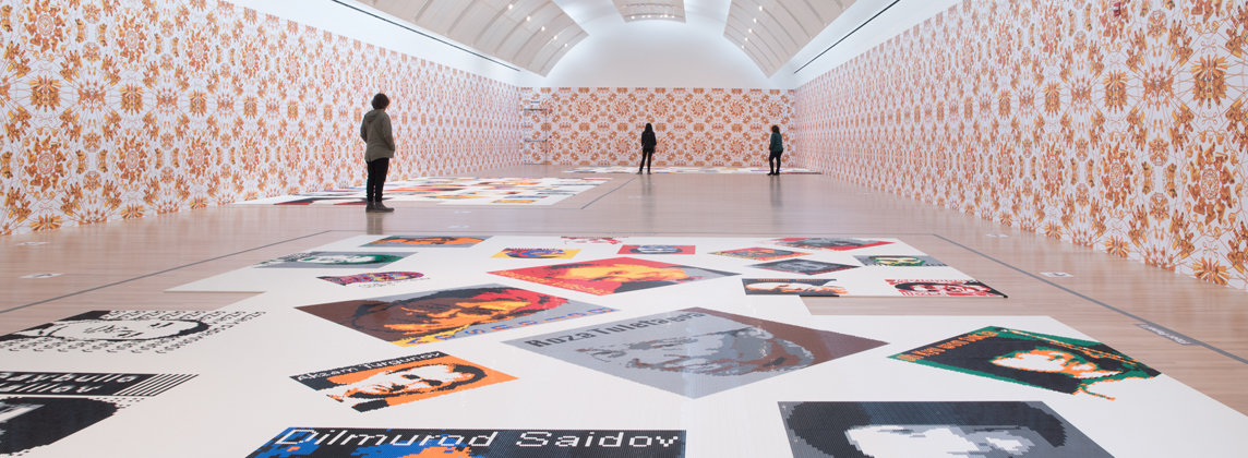 Wide shot of Ai Weiwei: Trace gallery with a few people in it