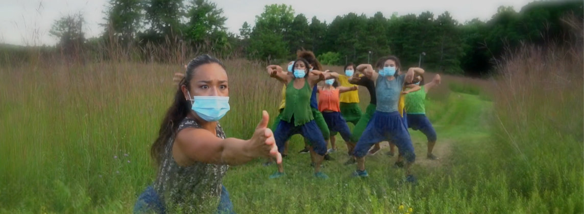 Ananya Dance Theatre performers in a grassy field
