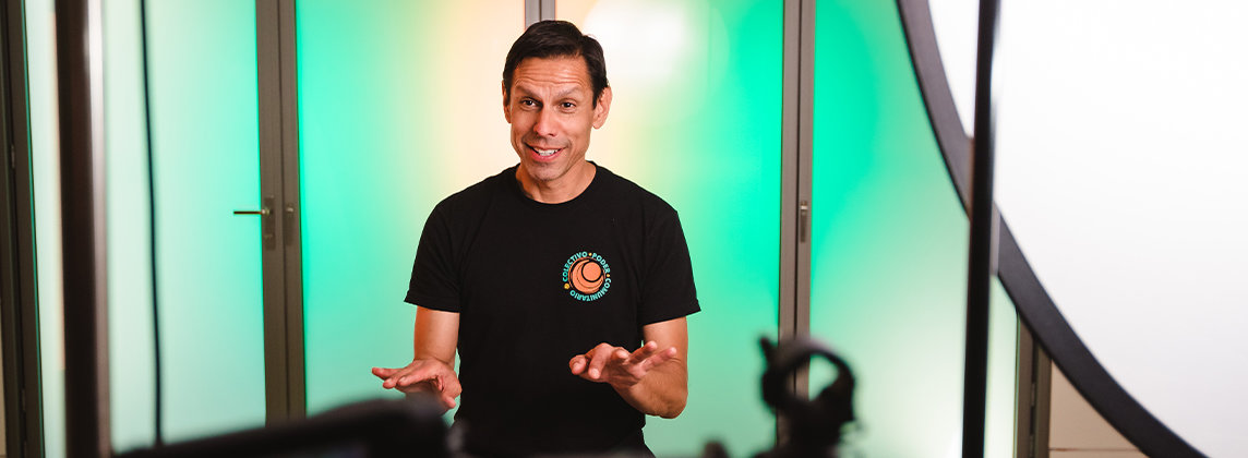 Quetzal Flores sitting in a studio being filmed speaking