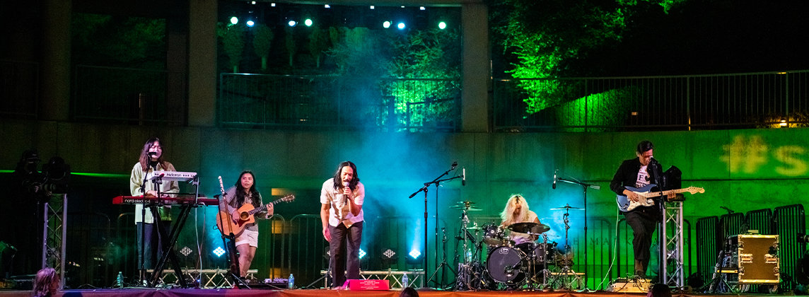 Photo of the band Run River North performing on an outdoor stage at the Skirball