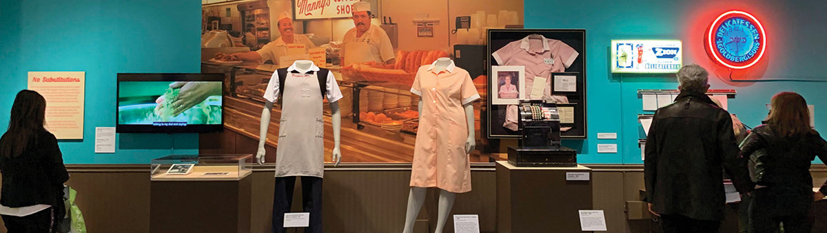 Photo of people looking at a display in The Jewish Deli gallery