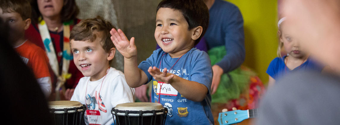 child playing a drum