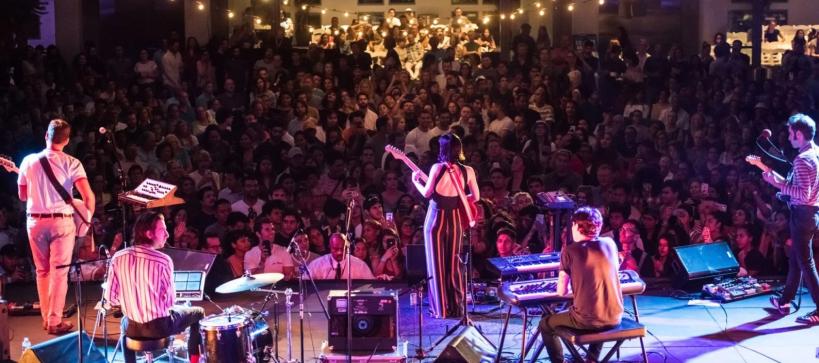 Band playing on a stage in front of a crowd of people