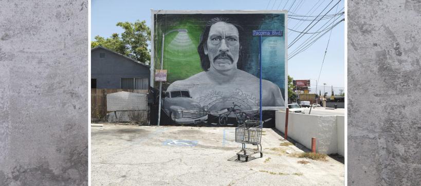 mural on the side of a building showing a bust of a man with a mustache