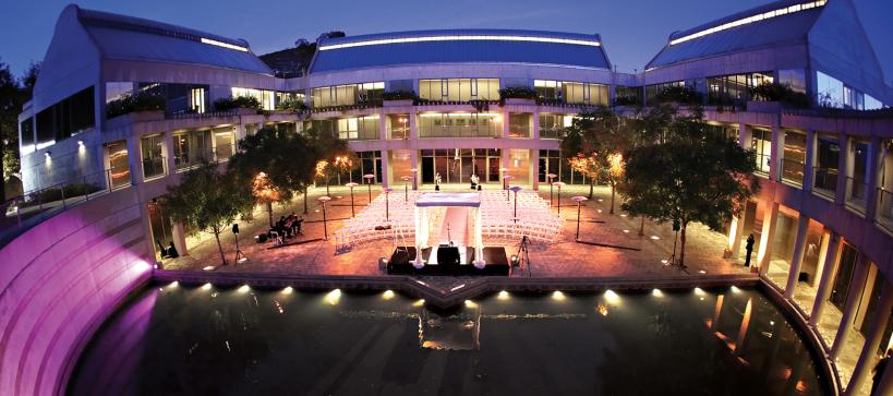 Wide angle image of Taper Courtyard lit up with blue and purple lights 
