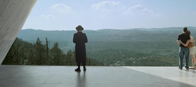Hasidic Jew and a man and woman holding each other at Yad Vashem