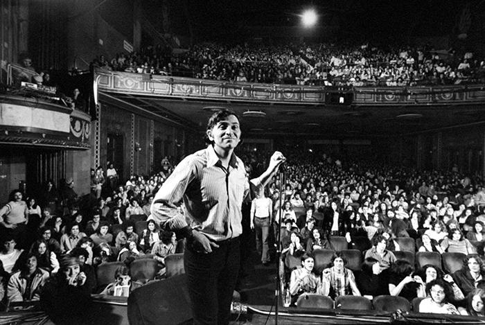 bill graham on stage in front of a large crowd