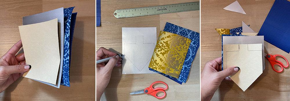 pieces of paper, drawing a dreidel outline on the paper, cutting the paper into a dreidel shape