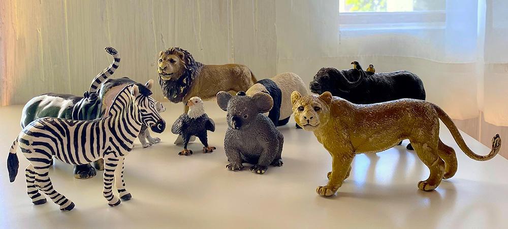 small toy animals: zebra, lion, tiger, koala, eagle