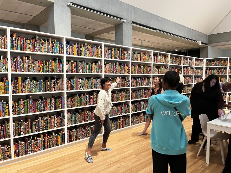 Vicki Phung Smith leads a tour of The American Library.
