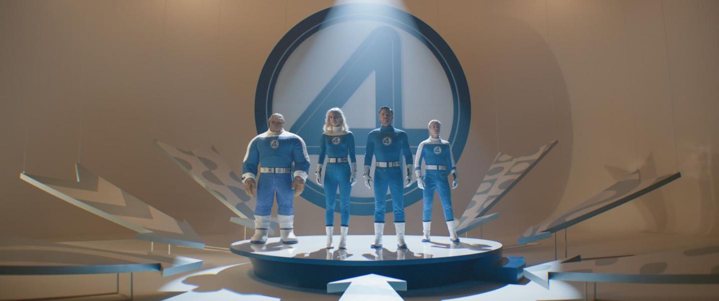 Four people in blue uniforms stand side by side