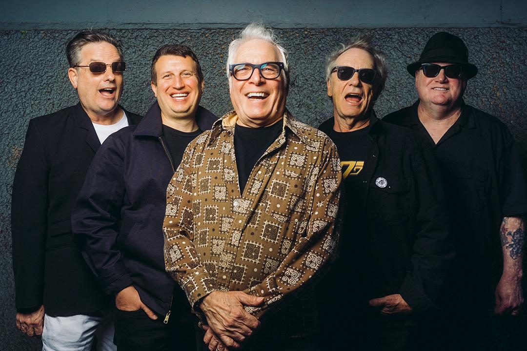 Five members of the band Roman's Weirdos smiling.