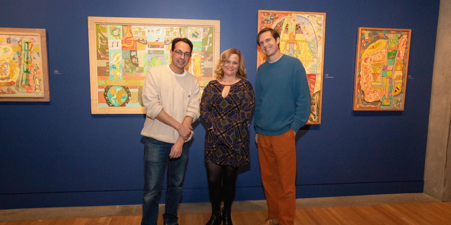Photo of curator Laura Mart between dublab's Alejandro Cohen and Mark Frosty McNeill standing in a gallery with colorful paintings behind them