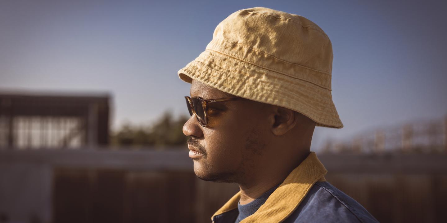 close up of Son Little's profile, he's facing left and wears a hat