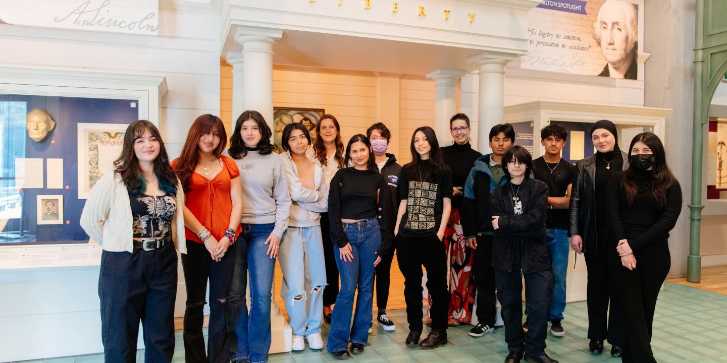 A group of students stands in the Visions & Values gallery.