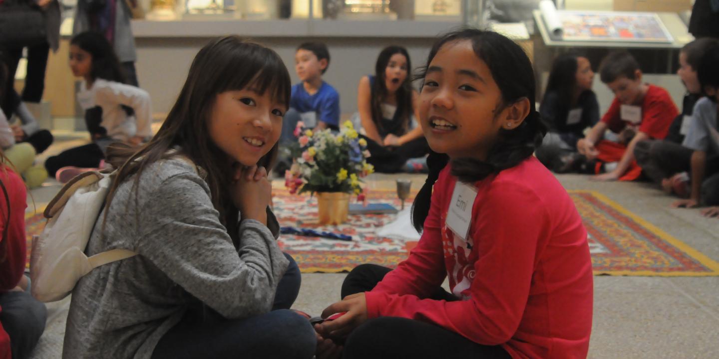 Two students on a school tour smile for the camera.