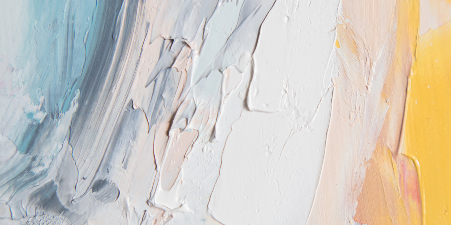 Detail of blue, white, and yellow acrylic paint spread onto a surface.