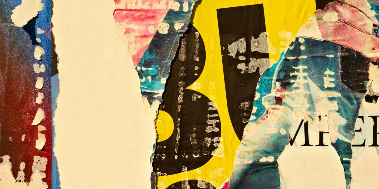 Detail of different colored paper cut and pasted together in a collage.