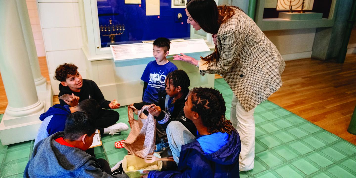 Students sit on the floor of the Liberty Gallery.