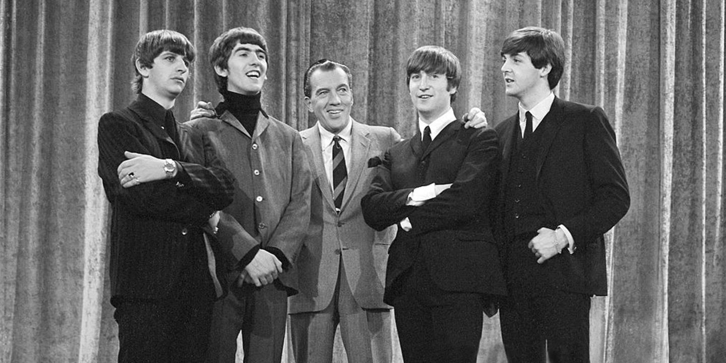 Ed Sulivan poses with the Beatles for his show.