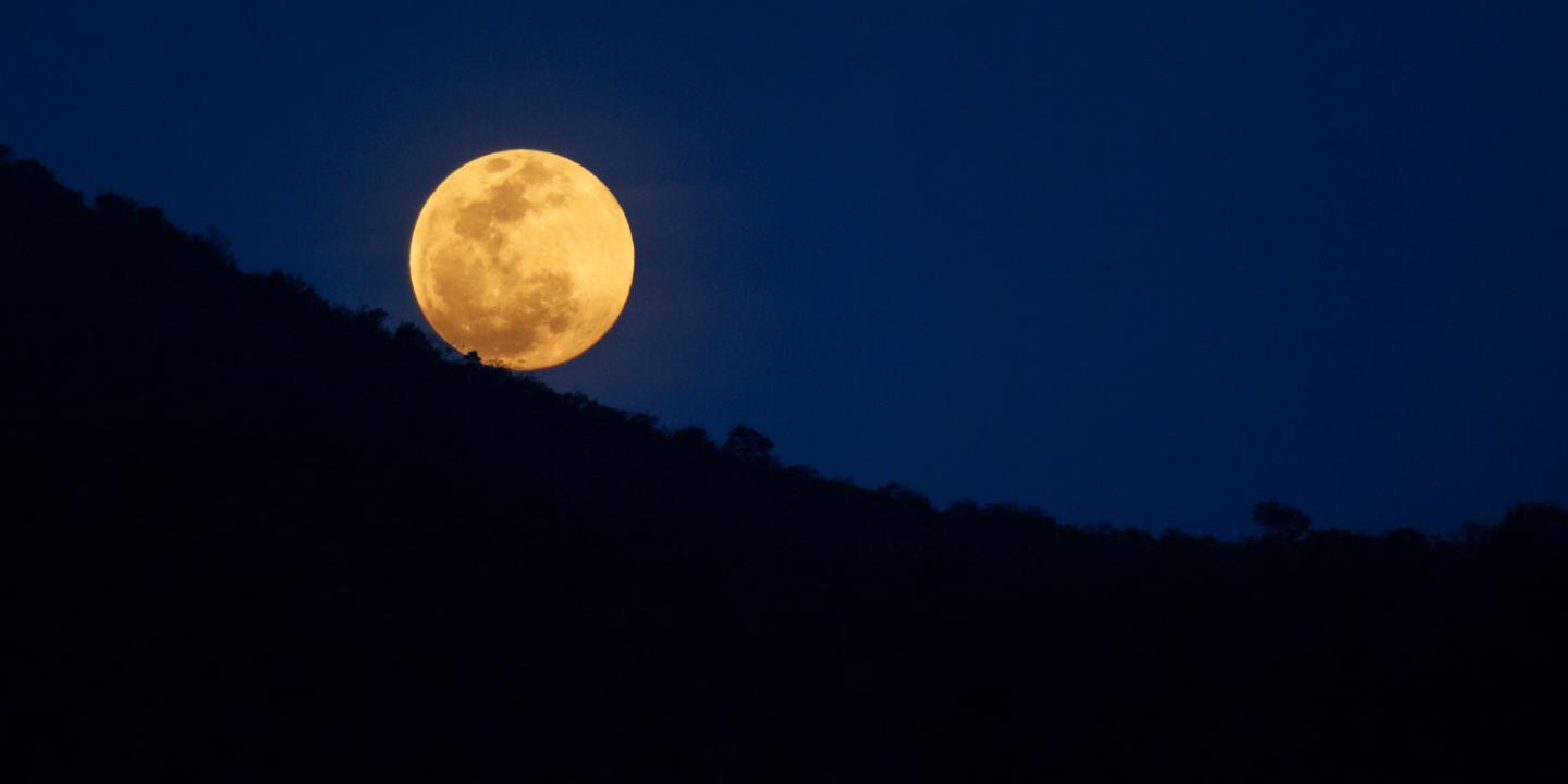 Full moon over the mountains.