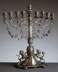 Silver Hanukkah lamp with a unicorn and a lion at the base