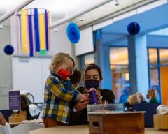 a woman and small boy making art