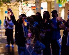 People standing together holding lanterns