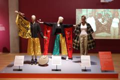 mannequins in exhibit wearing clothing with protest slogans