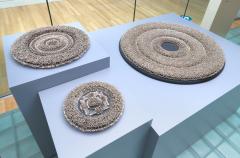 3 circular sculptures made of hundreds of safety pins
