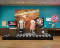 mannequins dressed as workers in a delicatessen