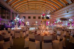 Guerin Pavilion set up for a festive occasion with circular tables and large floral centerpieces
