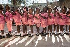 young students in school uniforms lined up in a row