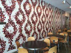 pomegranate wallpaper with tables and chairs arranged in front of it