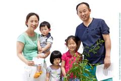 2 adults and 3 children with a small pomegranate tree