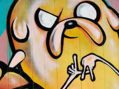 mural of a stylized dog with hands in front of it with fingers arranged to look like the letters LA