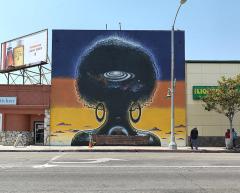 mural of a woman's hair in an Afro with a spiral galaxy painted on the hair