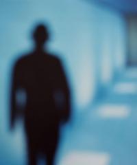 blurry image of a silhouette of a person in a hallway