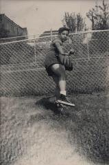 Photo of Paul Simon as a child throwing a baseball