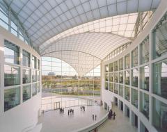 photo of building atrium with Lincoln Memorial in the distance visible through the windows