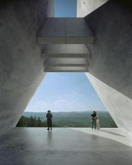 Hasidic Jew and a man and woman holding each other at Yad Vashem