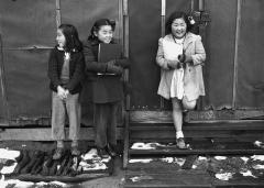 3 young girls standing outside with patches of snow on the ground