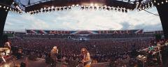 view from behind a band on stage looking out over a huge crowd of people